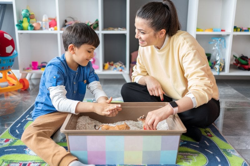 A Child engaging in a play therapy session with a therapist at Keller Child and Family Therapy